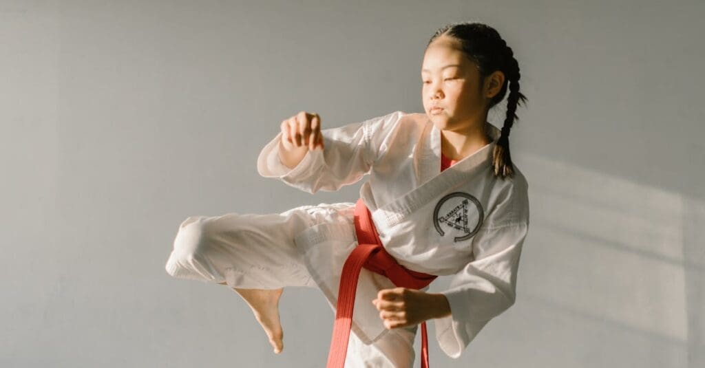 Young student practicing controlled kicking drills as part of martial arts training for beginners